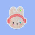 Sticker of a miffy character with a pink headband on a brown background